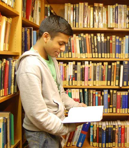 International Student Reading a book in a library