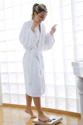 Woman About To Weigh Herself Woman About To Weigh Herself